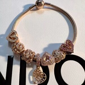 Authentic Pandora Rose gold snake bracelet w/ 7 Authentic charms.